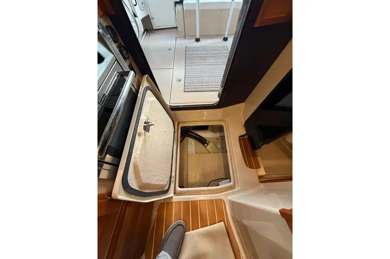Slide: The Image of 2016 Ranger Tugs R-31 CB interior with open hatch and wooden flooring. - 24