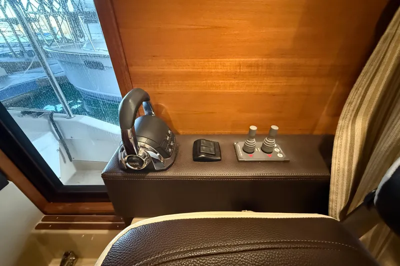Slide: The Image of Interior helm controls of 2016 Ranger Tugs R-31 CB boat, featuring throttle and joystick. - 32