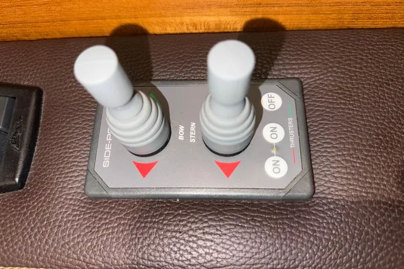 Slide: The Image of Joystick controls for 2016 Ranger Tugs R-31 CB boat thrusters on leather surface. - 33