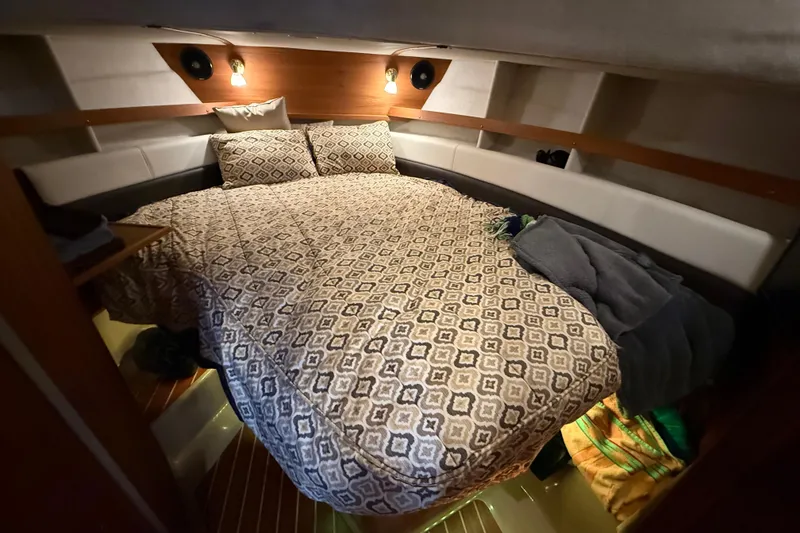 Slide: The Image of Cozy cabin interior of 2016 Ranger Tugs R-31 CB with patterned bedding and ambient lighting. - 39