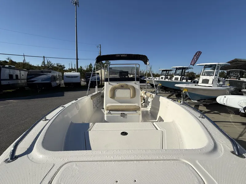 Slide: The Image of 2014 Key West 186br boat with seating, parked in a marina under clear blue sky. - 11