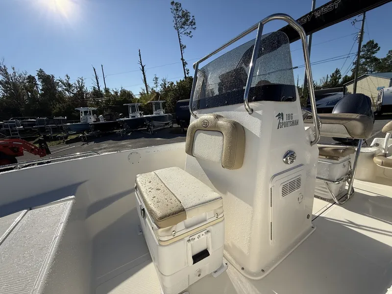 Slide: The Image of 2014 Key West 186br boat interior with console and seating under sunny sky. - 9