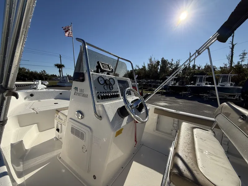 Slide: The Image of 2014 Key West 186br boat interior with steering console, under sunny sky. - 4