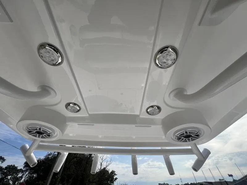 Slide: The Image of 2024 Blazer GTS 2550 BAY boat ceiling with speakers and rod holders. - 11