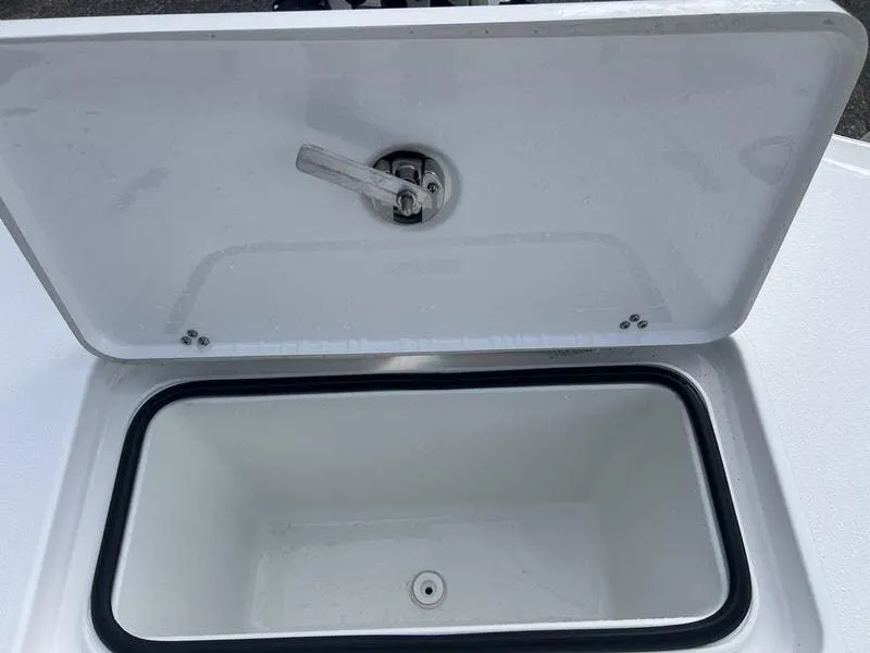 Slide: The Image of 2024 Blazer GTS 2550 BAY boat storage compartment with open lid, showcasing interior space. - 12