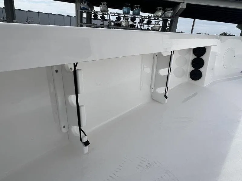 Slide: The Image of 2024 Blazer GTS 2550 BAY boat interior with rod holders and sleek white finish. - 13