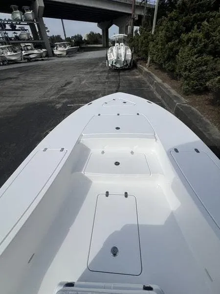 Slide: The Image of 2024 Blazer GTS 2550 BAY boat on trailer, parked under a bridge. - 14