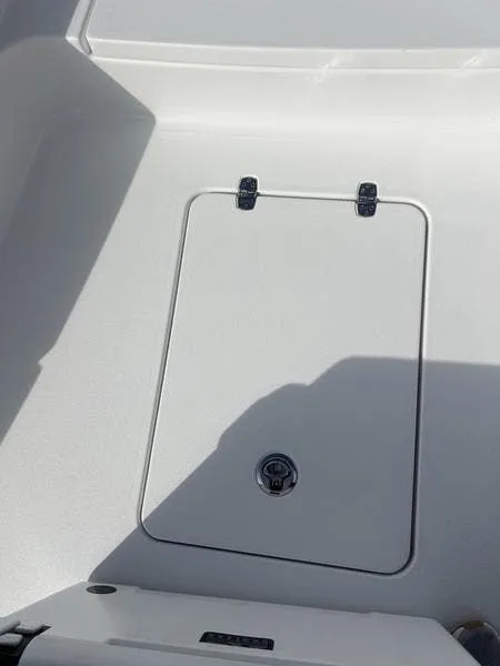 Slide: The Image of 2024 Blazer GTS 2550 BAY boat storage compartment with secure latch. - 15