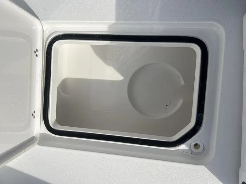 Slide: The Image of 2024 Blazer GTS 2550 BAY storage compartment, open lid, white interior, black seal. - 17