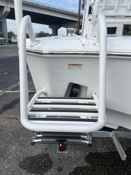 Slide: The Image of 2024 Blazer GTS 2550 BAY boat with a white boarding ladder. - 19