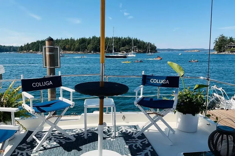 Slide: The Image of Deck view from 1999 Pacific Mariner 65 Motoryacht, featuring chairs and scenic ocean backdrop. - 12