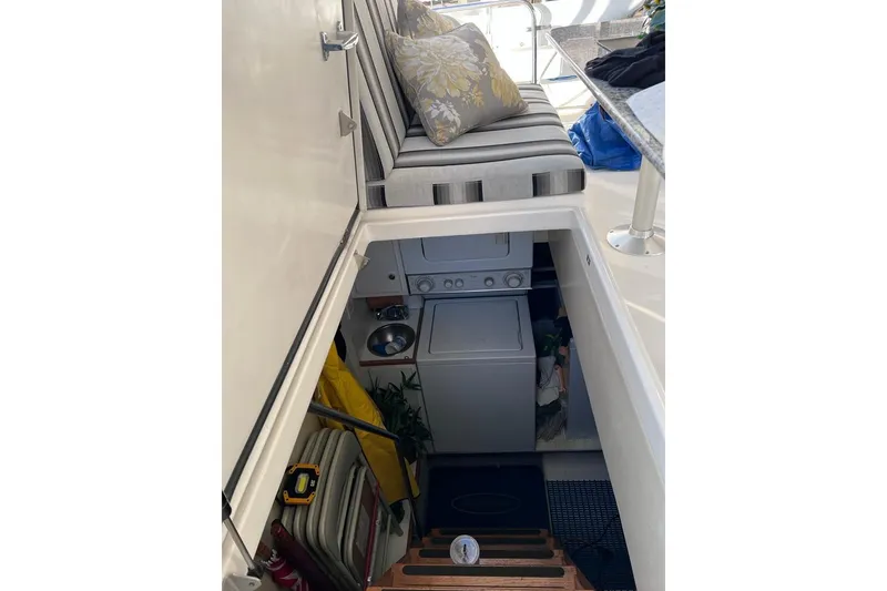 Slide: The Image of 1999 Pacific Mariner 65 Motoryacht interior with laundry area and seating. - 18