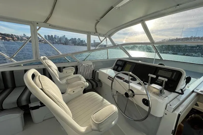 Slide: The Image of 1999 Pacific Mariner 65 Motoryacht helm with city skyline view through windows. - 25