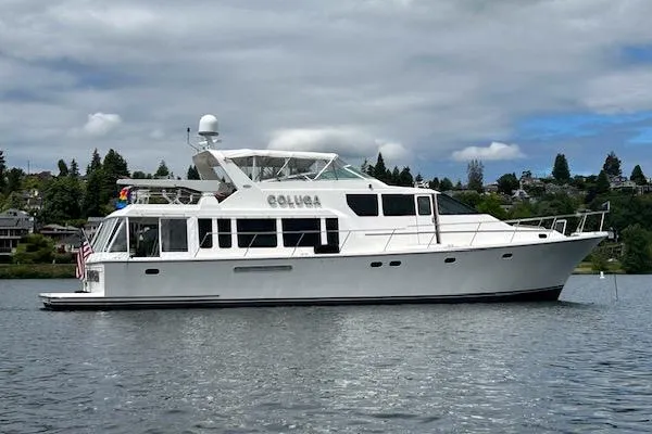Slide: The Image of 1999 Pacific Mariner 65 Motoryacht on a calm lake under cloudy skies. - 4
