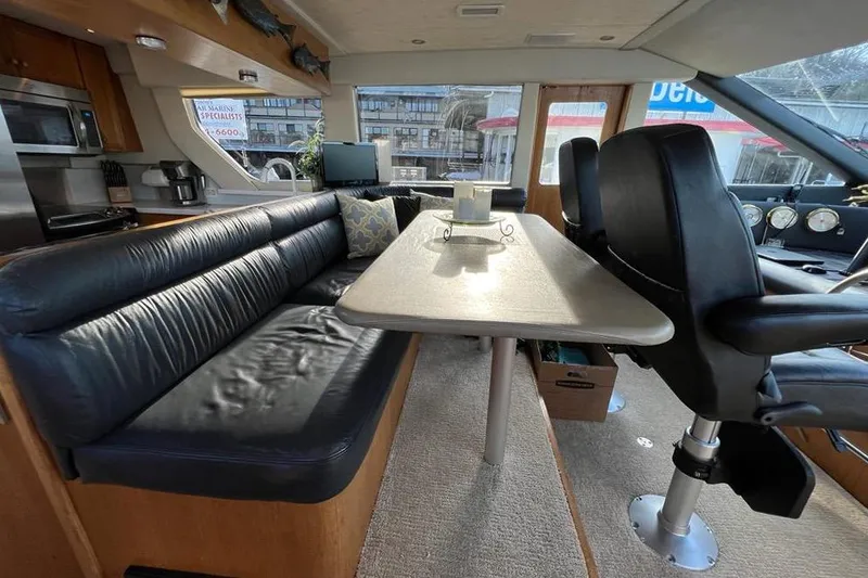 Slide: The Image of Interior of 1999 Pacific Mariner 65 Motoryacht with leather seating and dining table. - 40