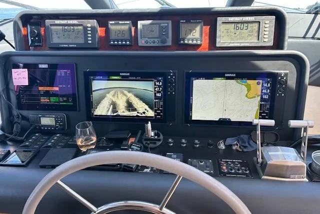 Slide: The Image of Control panel of a 1999 Pacific Mariner 65 Motoryacht with navigation screens and gauges. - 46