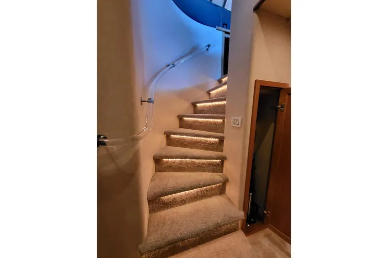 Slide: The Image of Carpeted staircase with LED lighting on a 1999 Pacific Mariner 65 Motoryacht. - 47