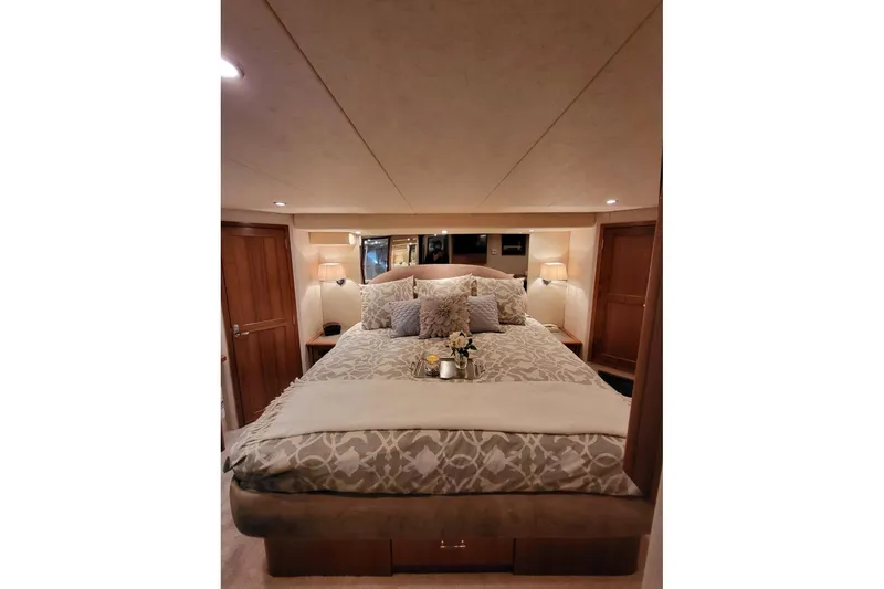 Slide: The Image of Luxurious bedroom interior of 1999 Pacific Mariner 65 Motoryacht with elegant bedding and warm lighting. - 49