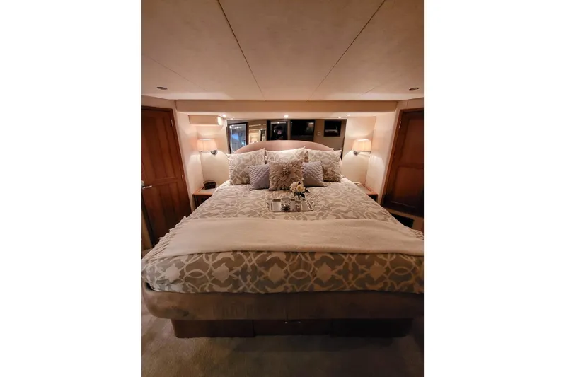 Slide: The Image of Luxurious bedroom interior of 1999 Pacific Mariner 65 Motoryacht with elegant bedding and soft lighting. - 50