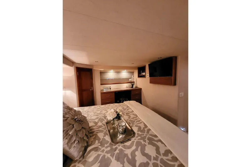 Slide: The Image of Luxurious bedroom interior of 1999 Pacific Mariner 65 Motoryacht with elegant decor and modern amenities. - 51