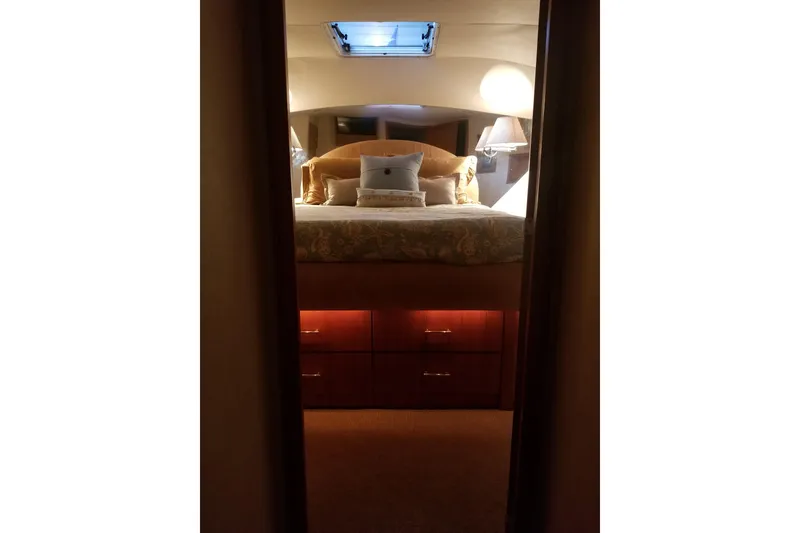 Slide: The Image of Luxurious bedroom interior of 1999 Pacific Mariner 65 Motoryacht with elegant bedding and lighting. - 55