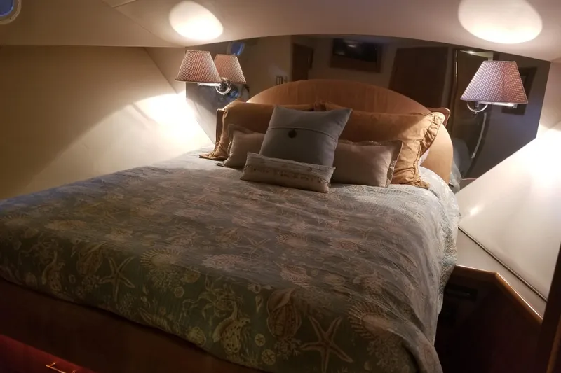 Slide: The Image of Luxurious bedroom interior of 1999 Pacific Mariner 65 Motoryacht with elegant bedding and lighting. - 57