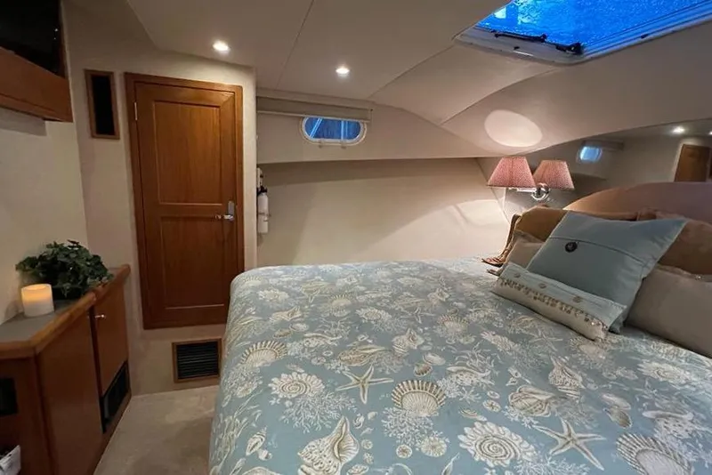Slide: The Image of Luxurious bedroom interior of 1999 Pacific Mariner 65 Motoryacht with elegant bedding and soft lighting. - 58