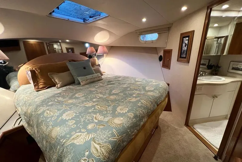 Slide: The Image of Luxurious bedroom in 1999 Pacific Mariner 65 Motoryacht with elegant bedding and ensuite bathroom. - 60