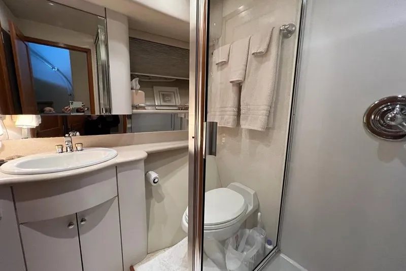 Slide: The Image of Bathroom interior of a 1999 Pacific Mariner 65 Motoryacht, featuring a shower and sink. - 68