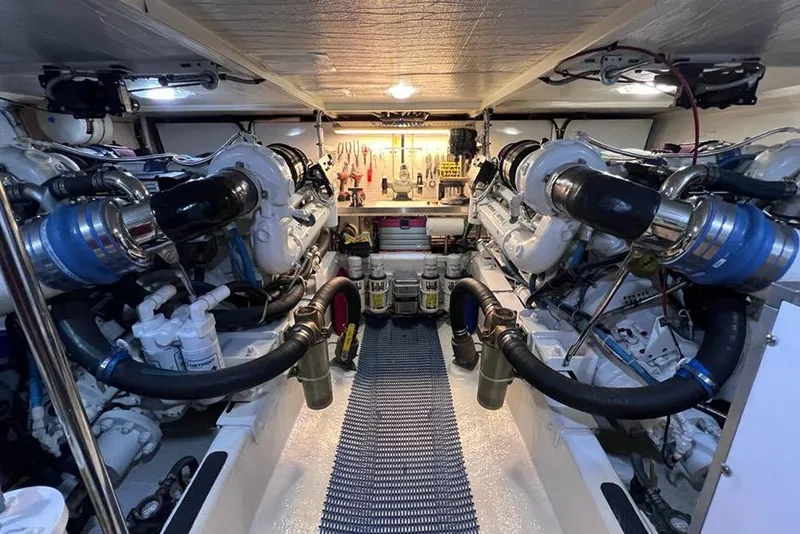 Slide: The Image of Engine room of a 1999 Pacific Mariner 65 Motoryacht, featuring dual engines and organized tools. - 71