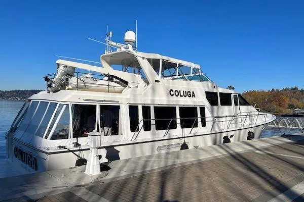 Slide: The Image of 1999 Pacific Mariner 65 Motoryacht docked on a sunny day, featuring sleek design and spacious deck. - 9