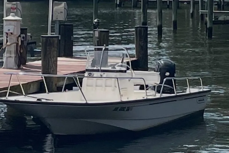 Slide: The Image of 2008 Boston Whaler 170 Montauk boat docked at a marina. - 1