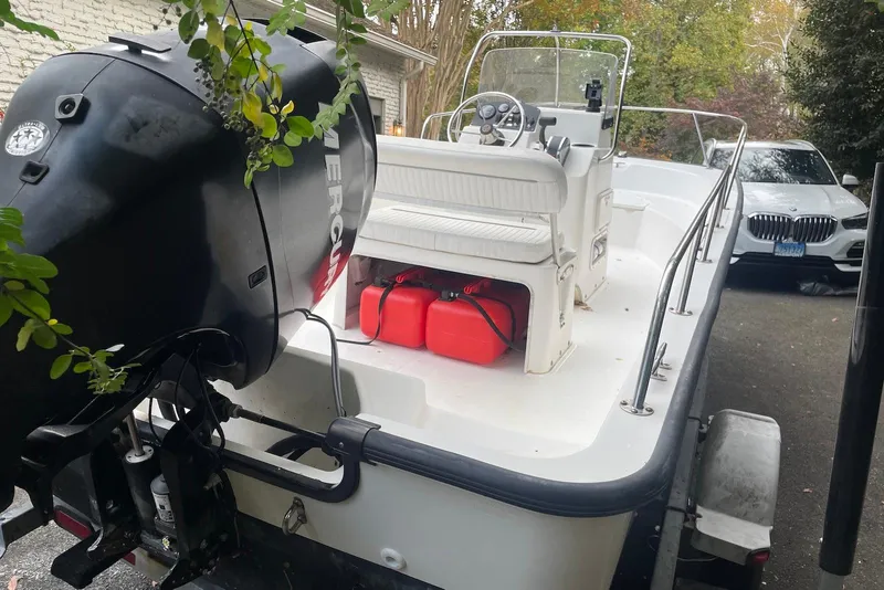 Slide: The Image of 2008 Boston Whaler 170 Montauk boat with Mercury engine, parked on a trailer. - 3