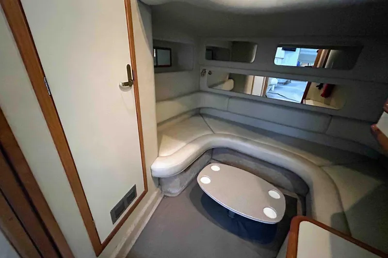 Slide: The Image of Interior of 1997 Sea Ray 450 Sundancer yacht with cozy seating and table. - 12