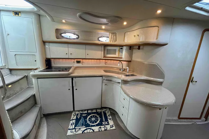 Slide: The Image of Luxurious 1997 Sea Ray 450 Sundancer yacht kitchen with modern amenities and elegant design. - 13
