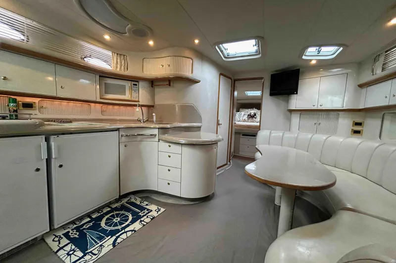 Slide: The Image of Luxurious interior of a 1997 Sea Ray 450 Sundancer yacht with modern amenities. - 15