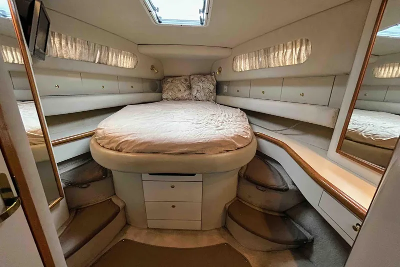 Slide: The Image of Luxurious cabin interior of 1997 Sea Ray 450 Sundancer yacht with cozy bed and storage. - 17