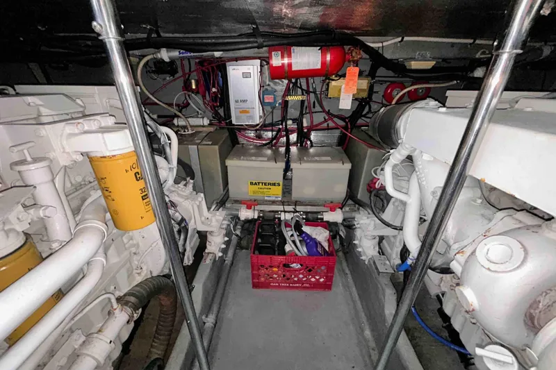 Slide: The Image of Engine room of a 1997 Sea Ray 450 Sundancer with visible batteries and wiring. - 19