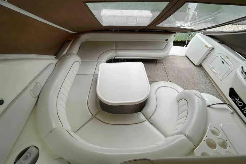 Slide: The Image of 1997 Sea Ray 450 Sundancer interior with white seating and table. - 9