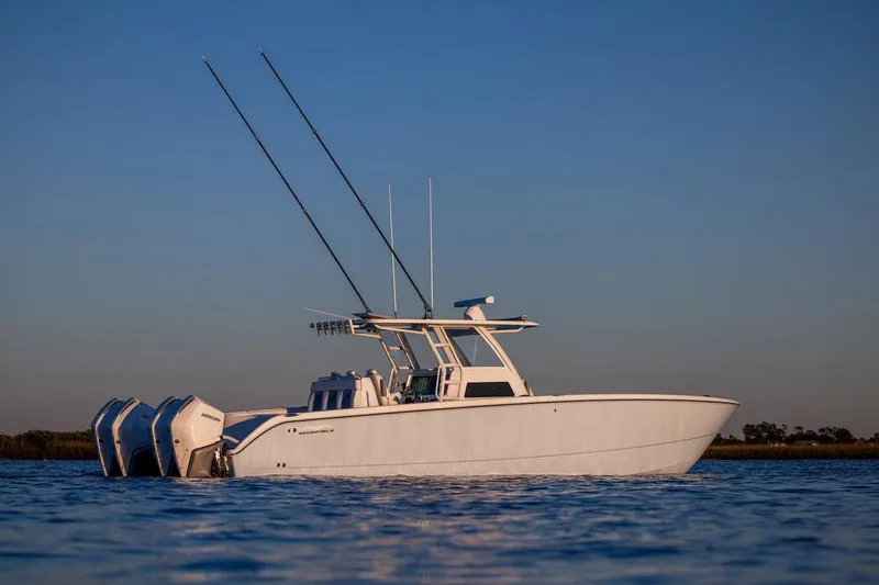 The Image of 2026 Invincible 38 Catamaran on calm water at sunset. - 1