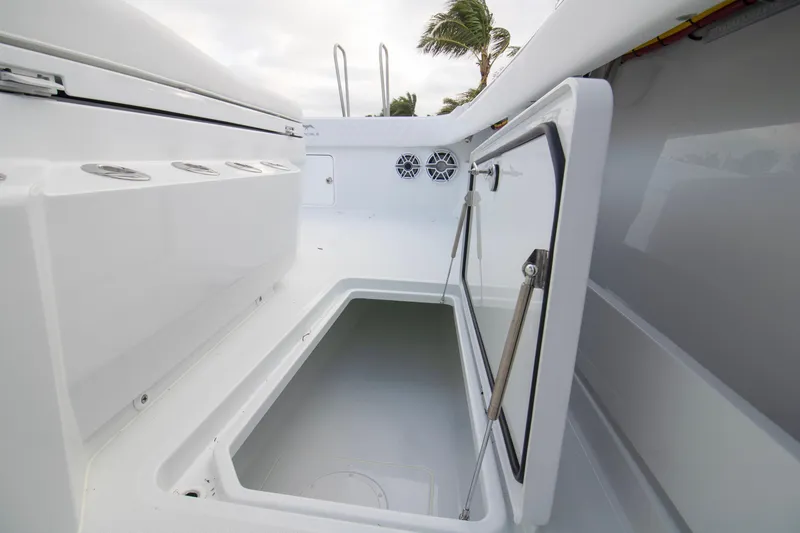 Slide: The Image of 2026 Invincible 38 Catamaran storage compartment with open hatch, showcasing sleek design and functionality. - 11