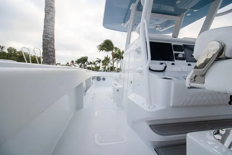 Slide: The Image of 2026 Invincible 38 Catamaran interior with modern helm and seating, surrounded by tropical scenery. - 16