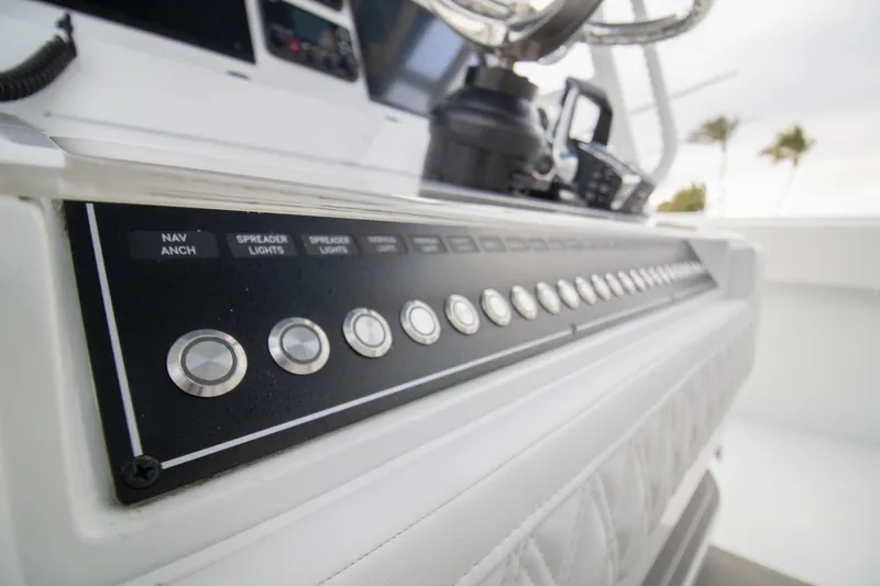 Slide: The Image of Control panel of 2026 Invincible 38 Catamaran with labeled buttons and switches. - 7