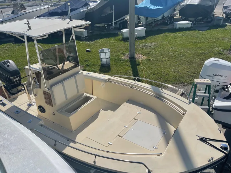 Slide: The Image of 1986 Gulf Stream Yachts custom boat with center console and canopy, docked at marina. - 14