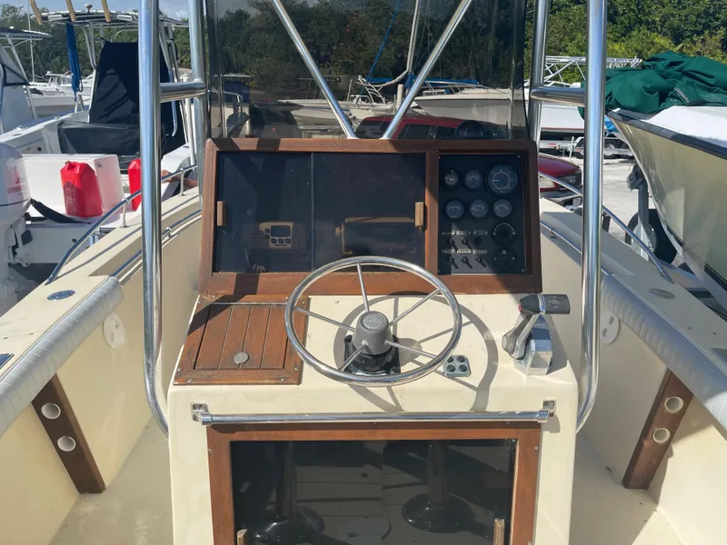 Slide: The Image of 1986 Gulf Stream Yachts custom boat dashboard with steering wheel and control panel. - 15