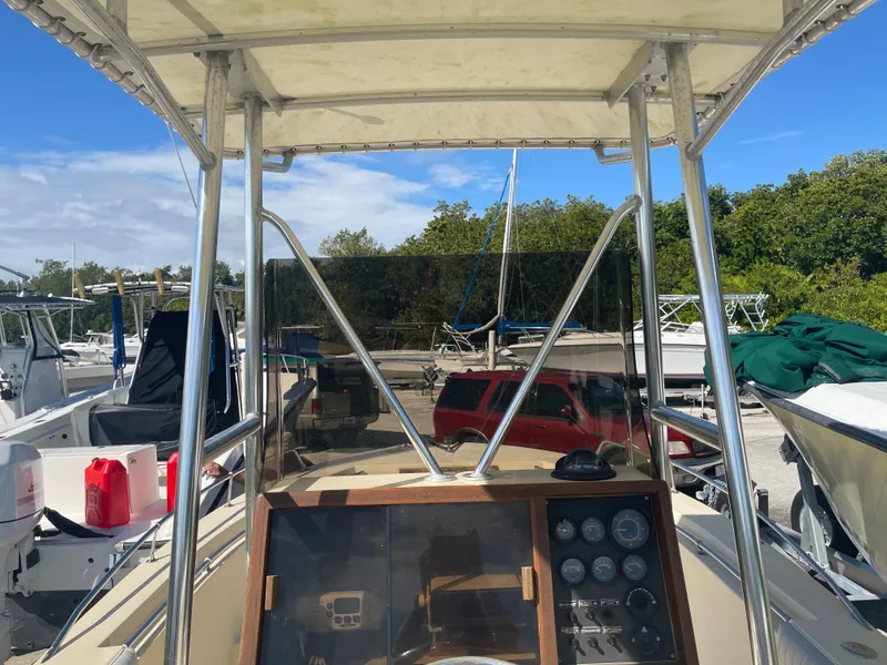 Slide: The Image of 1986 Gulf Stream Yachts custom boat dashboard and controls at marina. - 16