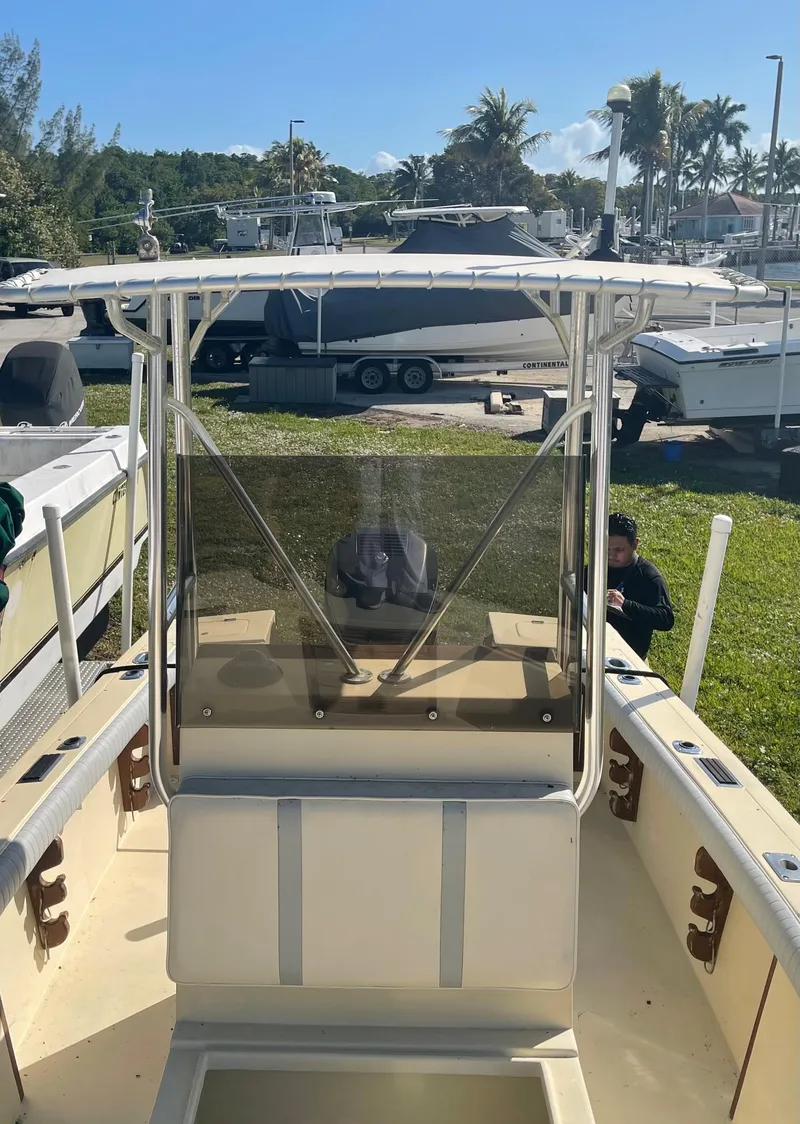 Slide: The Image of 1986 Gulf Stream Yachts custom boat with center console and T-top in a marina. - 25