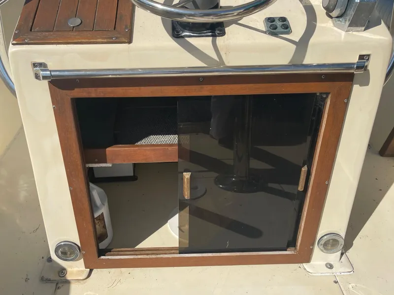 Slide: The Image of 1986 Gulf Stream Yachts custom model helm station with wooden storage cabinet. - 28