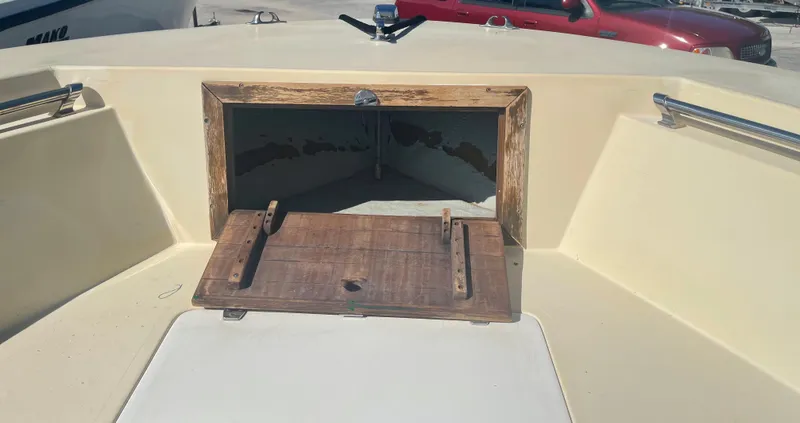 Slide: The Image of 1986 Gulf Stream Yachts custom boat with open storage compartment and wooden hatch. - 29
