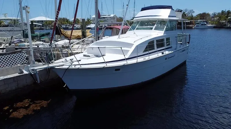 Slide: The Image of 1974 Bertram 42 Motor Yacht docked in a marina, showcasing classic design and sleek lines. - 1